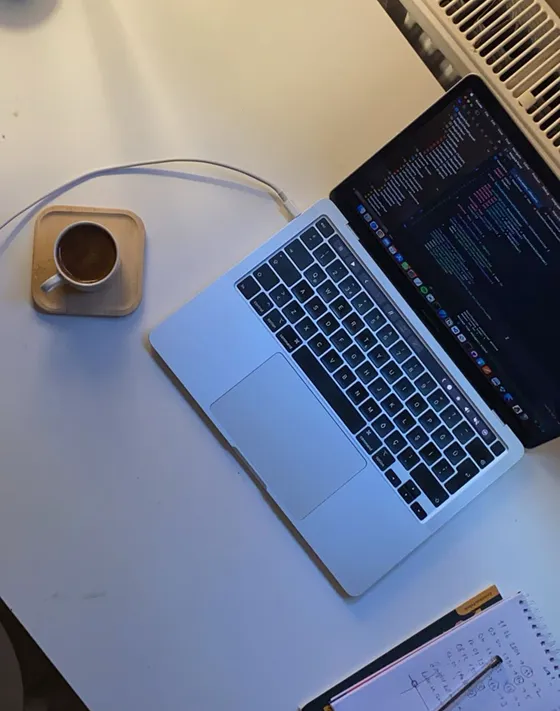 Laptop, coffee and notes on the desk