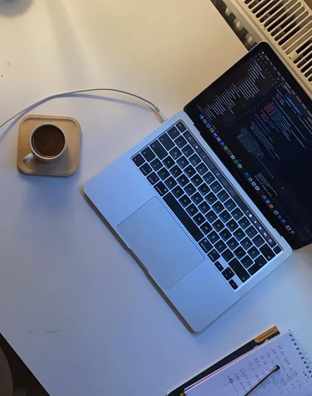 Laptop, coffee and notes on the desk